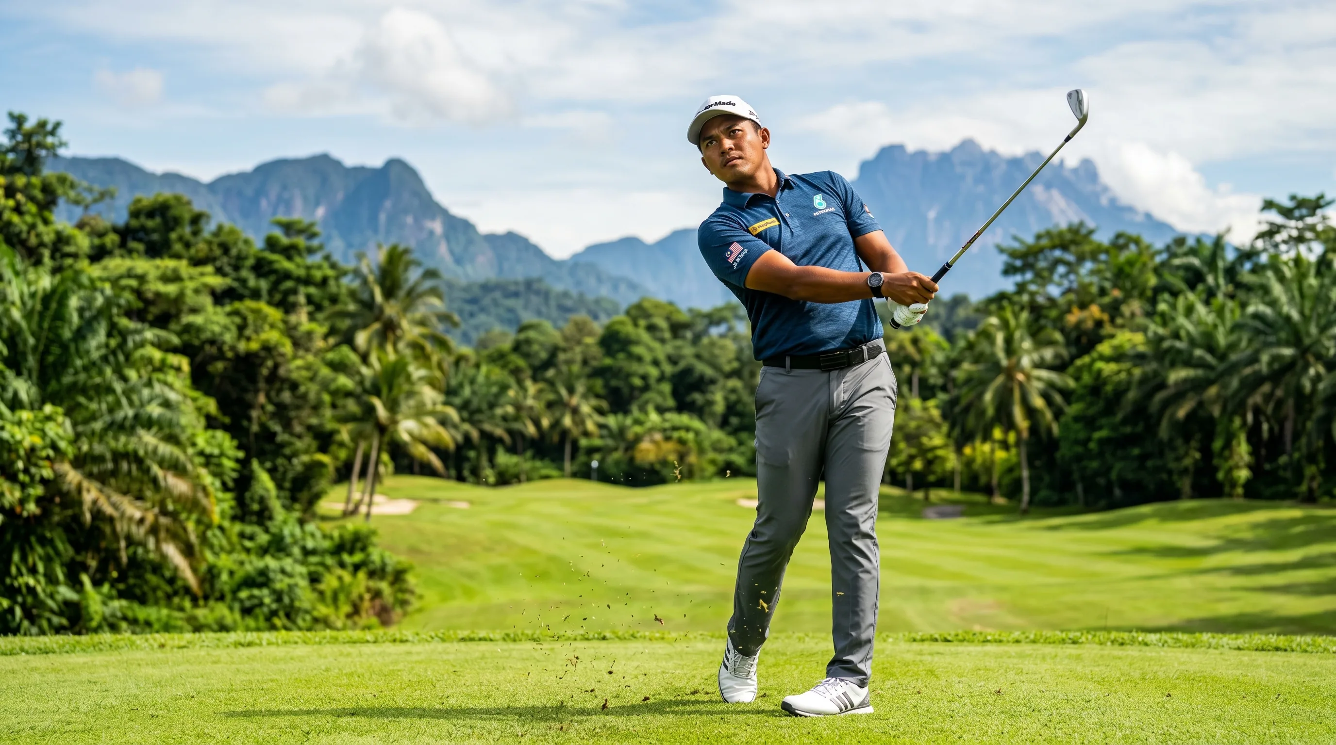 A Malaysian professional golfer following through on a fairway shot under bright tropical light, evoking Sabah's Ben Leong